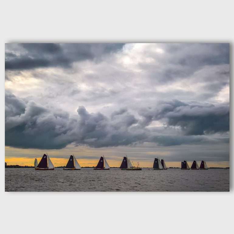 Wanddecoratie In Line – Skutsjezeilen in Friesland, zeilschepen in lijn onder donkere wolken